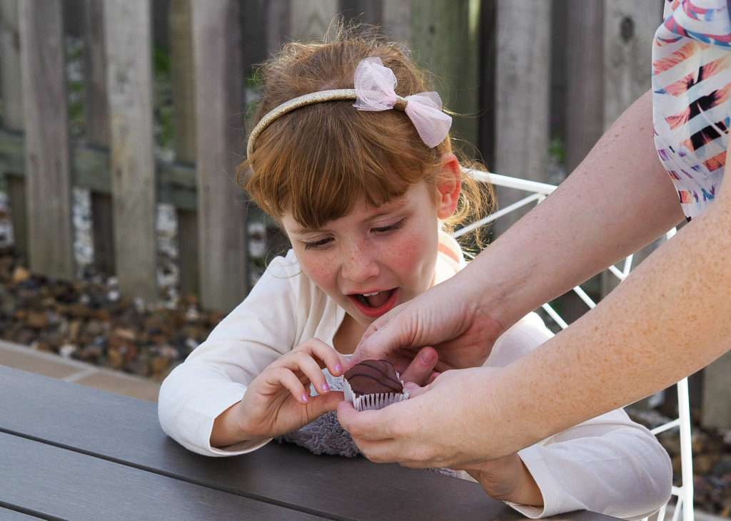 Young child being given treat